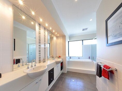 Custom built house interior white bathroom and red towels